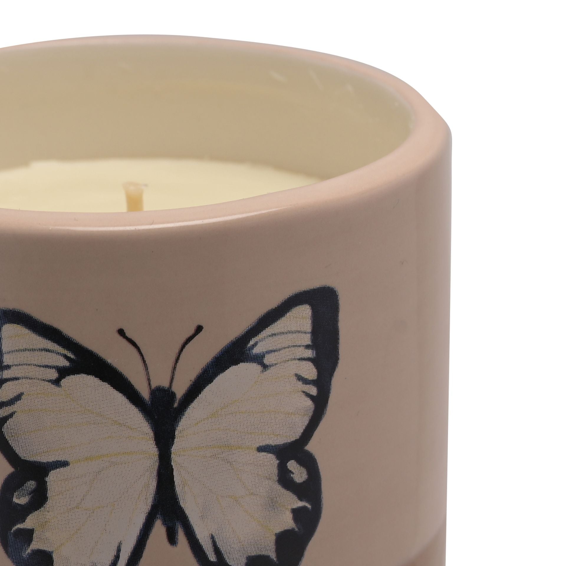 Candle in a ceramic holder with a butterfly design on a white background