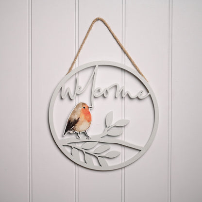 Decorative wall hanging with 'Welcome' text and a robin design on a light gray background.