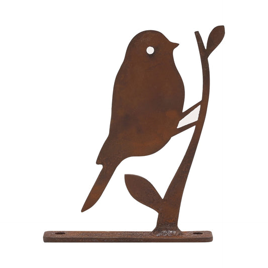 Decorative metal bird on a branch with rusted brown finish on a white background