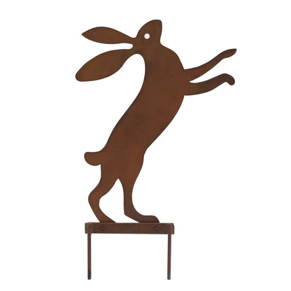 Rust-colored metal rabbit sculpture on a white background