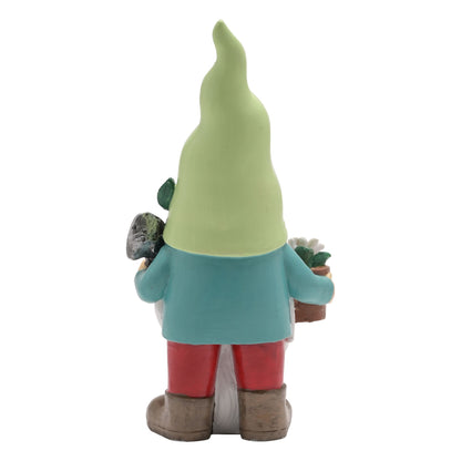 Gnome figurine with a green hat, blue shirt, red pants, and brown shoes holding plants on a white background