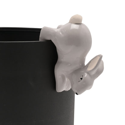 Gray ceramic planter with a rabbit design on a white background