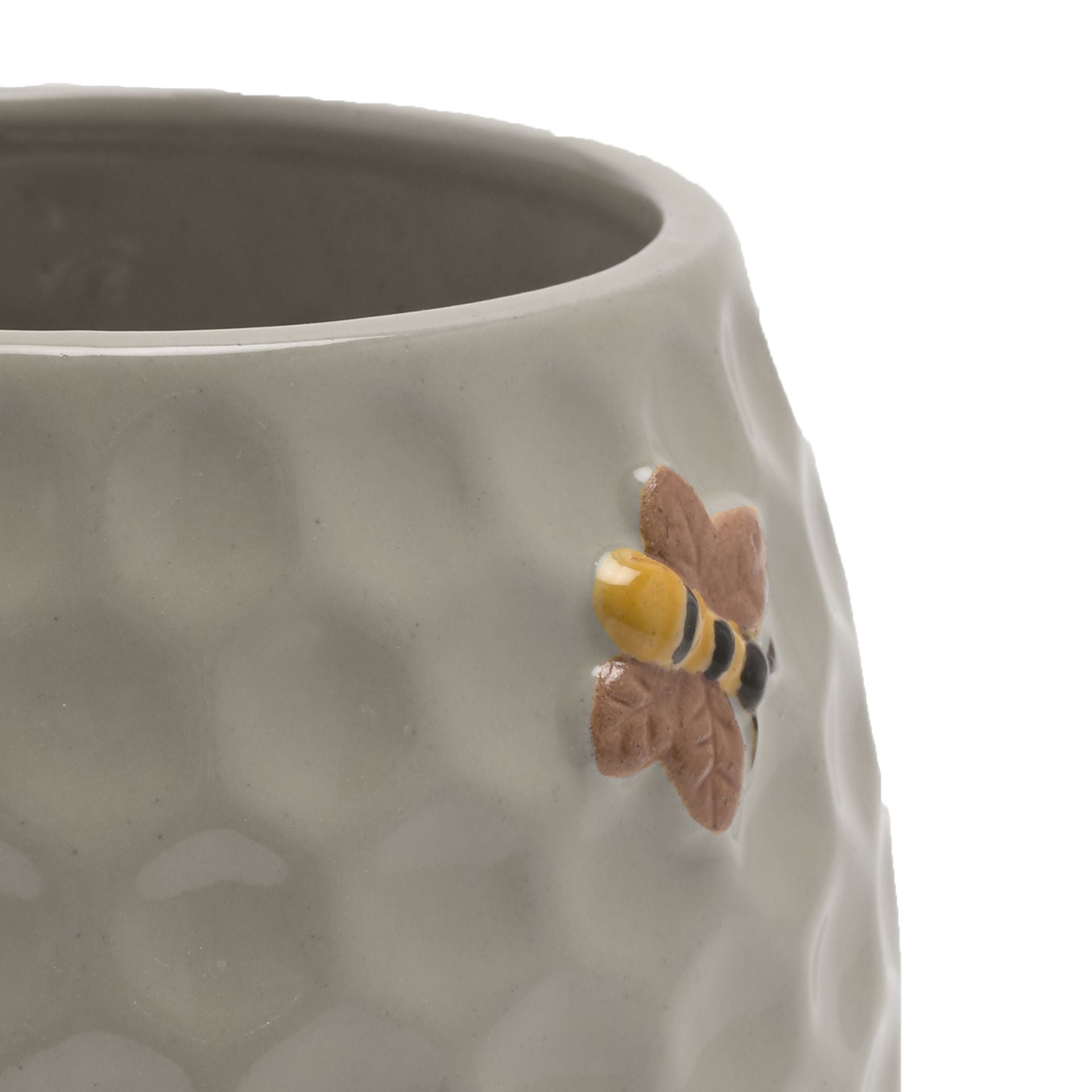 Ceramic planter with honeycomb design and bee decoration on a white background