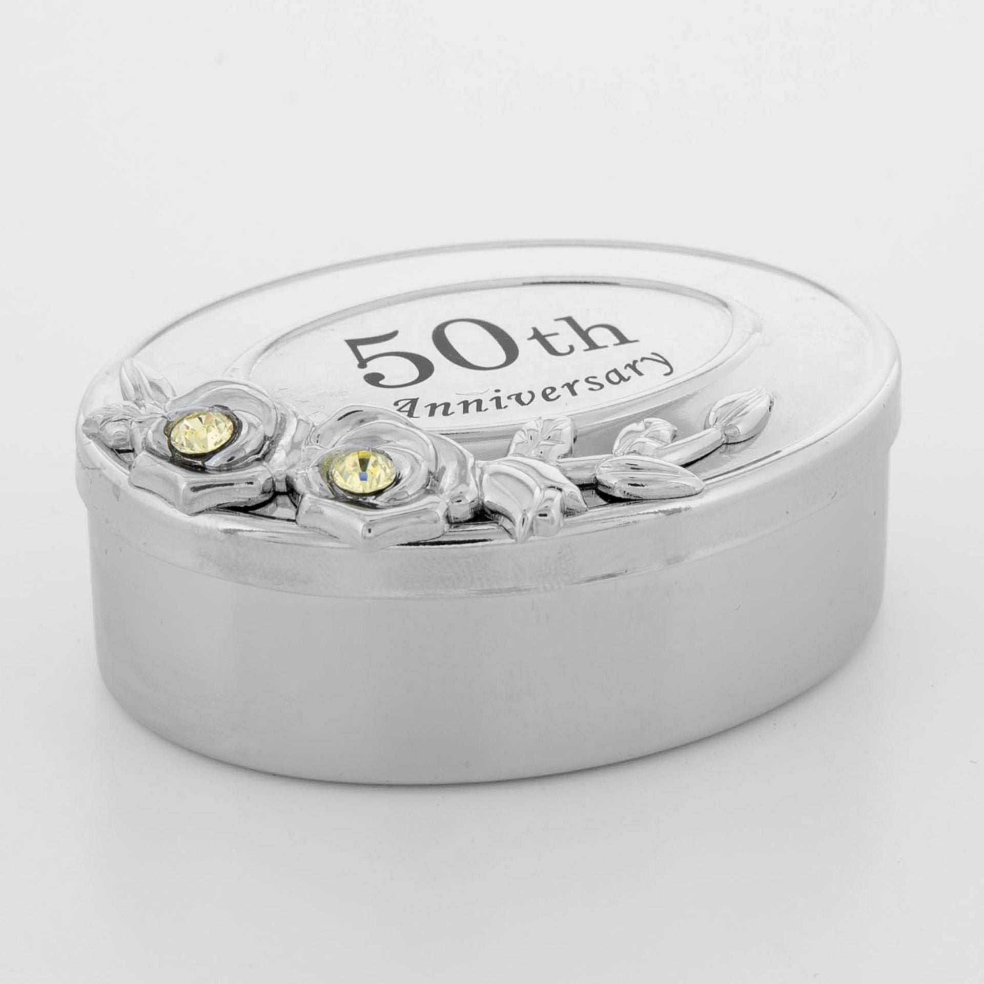 Silver 50th anniversary jewelry box with floral design and gemstones on a white background