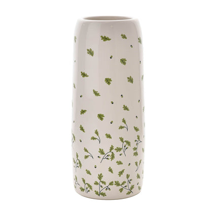 Cylindrical vase with green leaf pattern on a white background