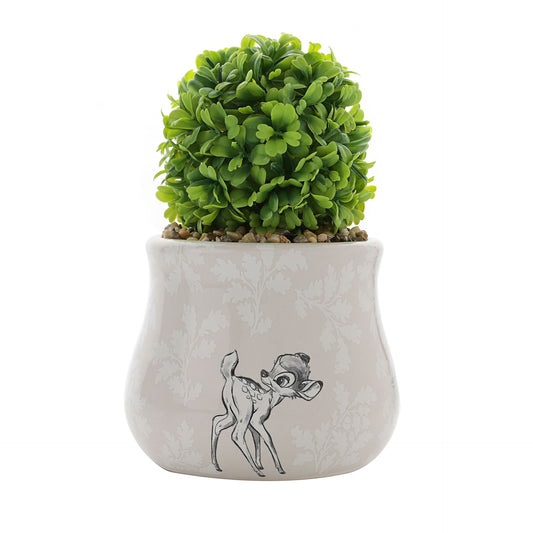 Green potted plant in a decorative pot with a dog illustration on a white background