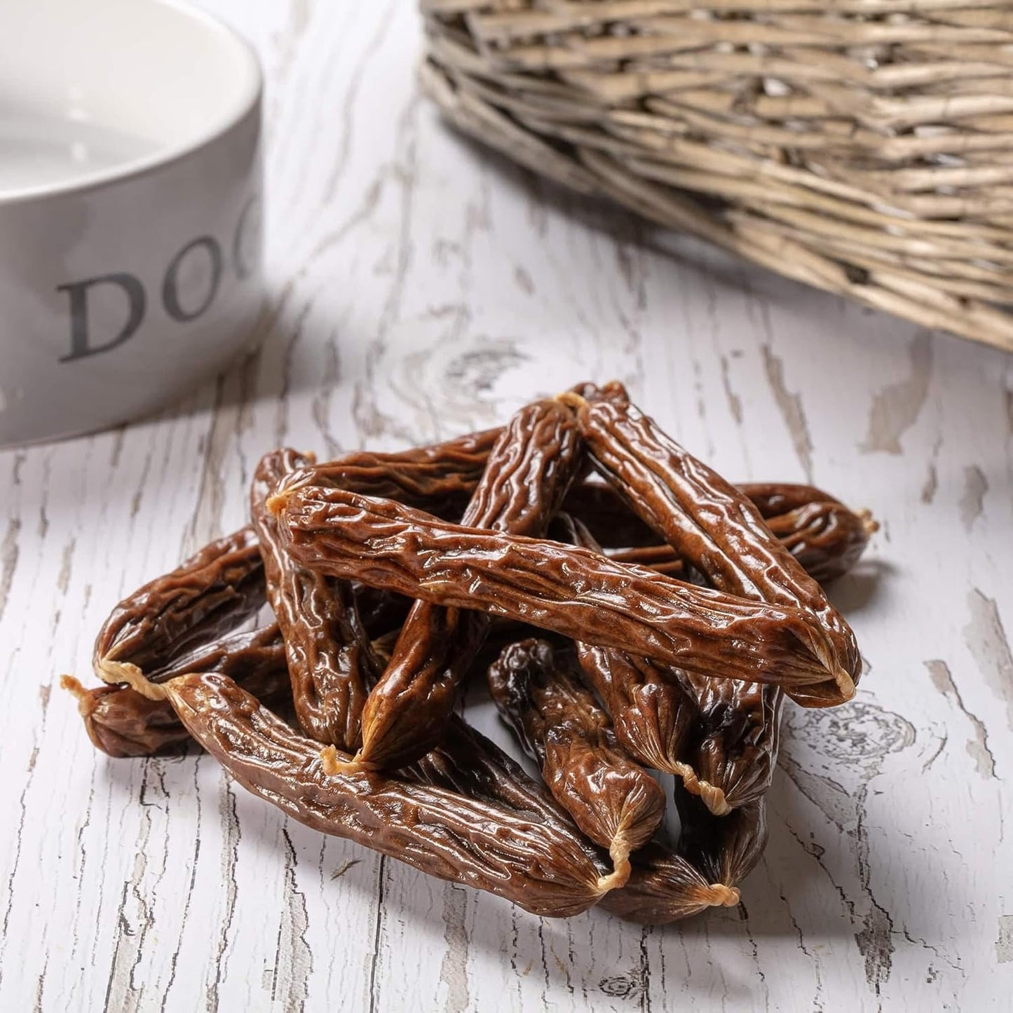 Hollings Gourmet Pork Sausages on a table next to a white dog bowl