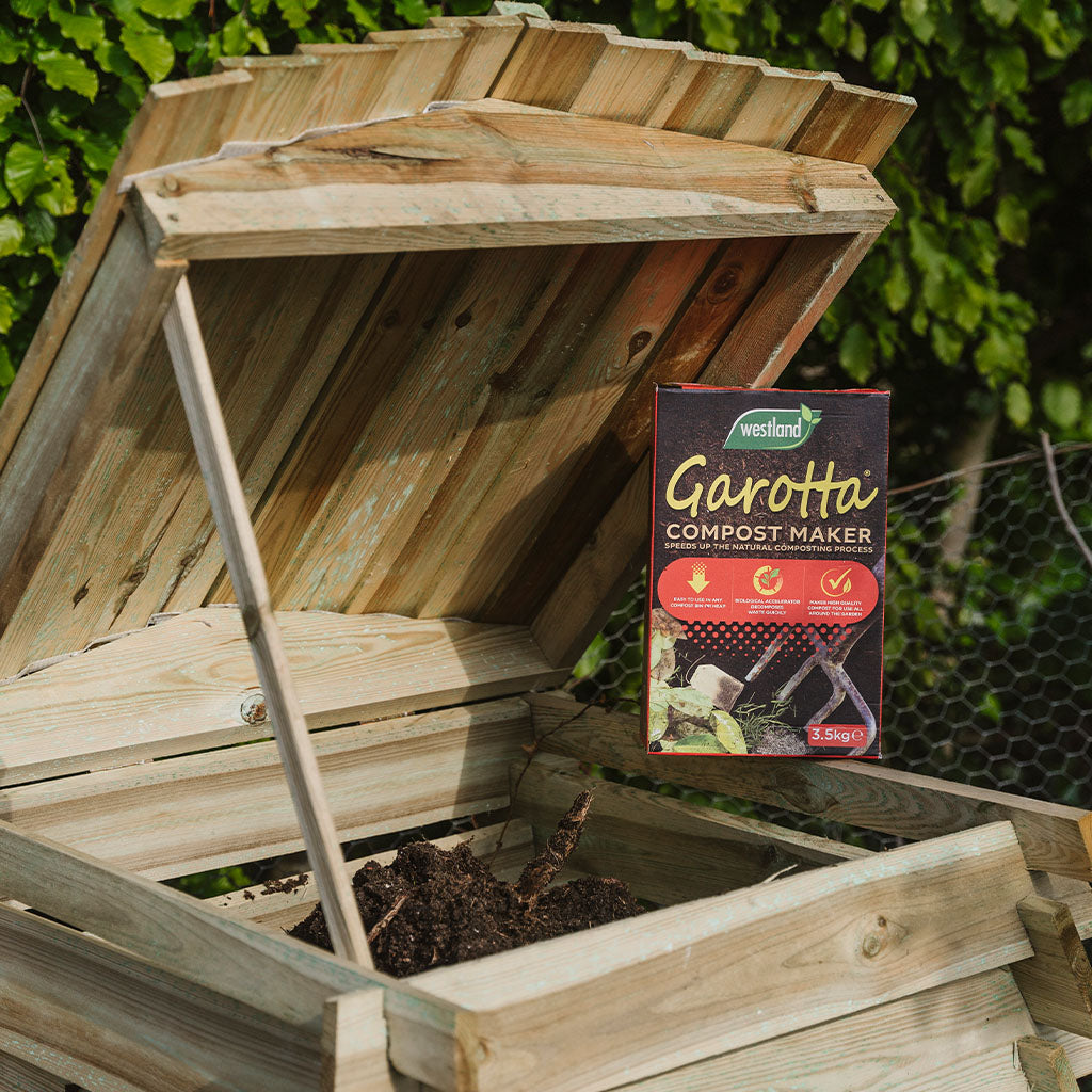 Westland Garotta Compost Maker 3.5KG on top of a filled, wooden compost bin