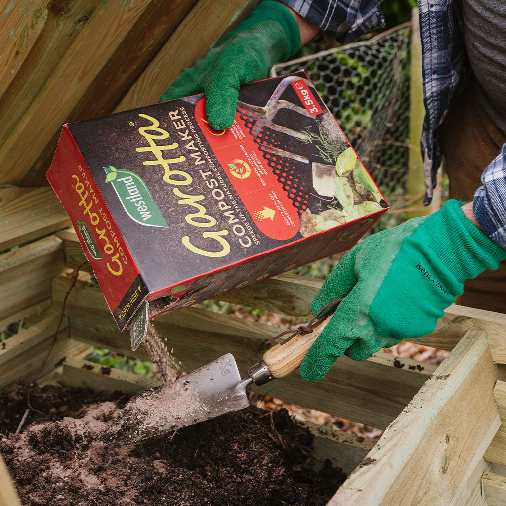 Westland Garotta Compost Maker 3.5KG being poured into a wooden compost bin