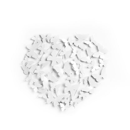 White butterfly cutouts scattered on a white background