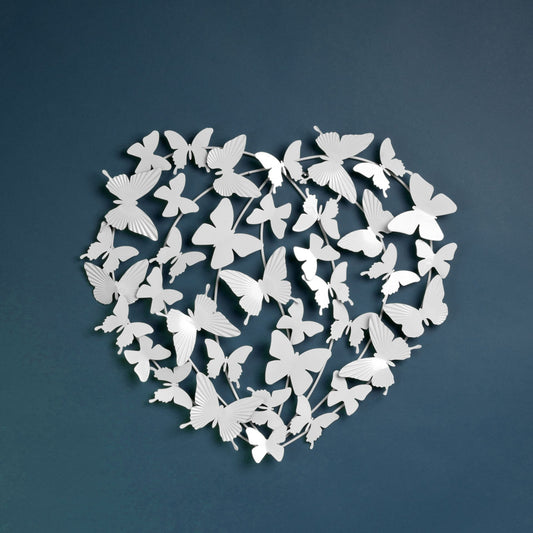 Heart-shaped arrangement of white butterflies on a dark blue background