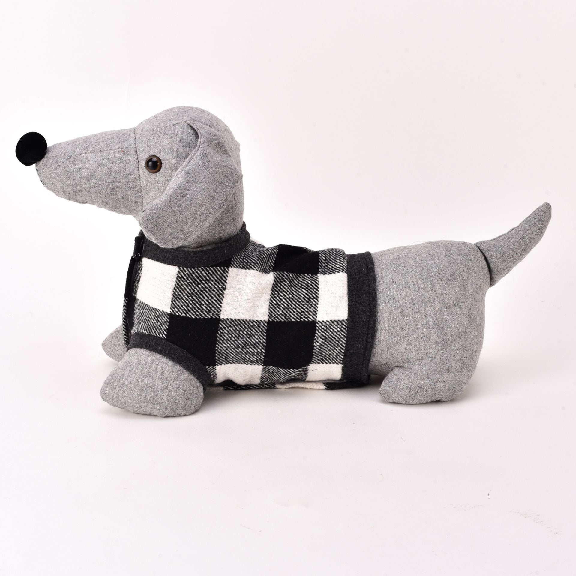 Gray plush dachshund toy wearing a black and white checkered sweater on a white background