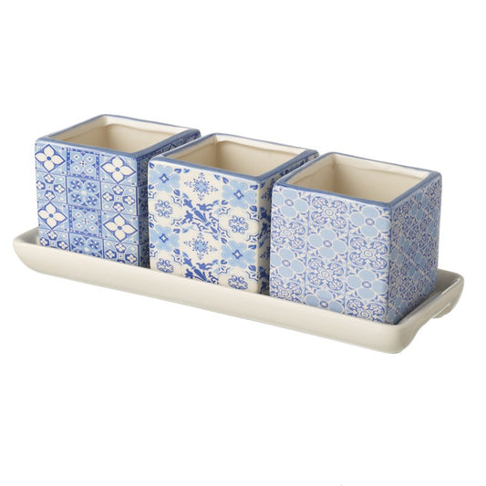 Set of three decorative ceramic containers with a floral pattern on a matching tray.