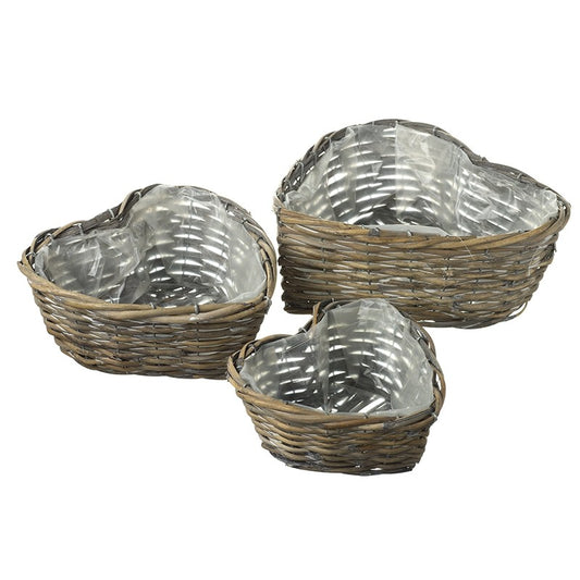 Three wicker baskets with metallic interior on a white background