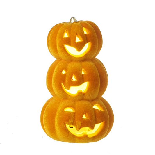 Stack of glowing orange jack-o'-lantern candles on a white background