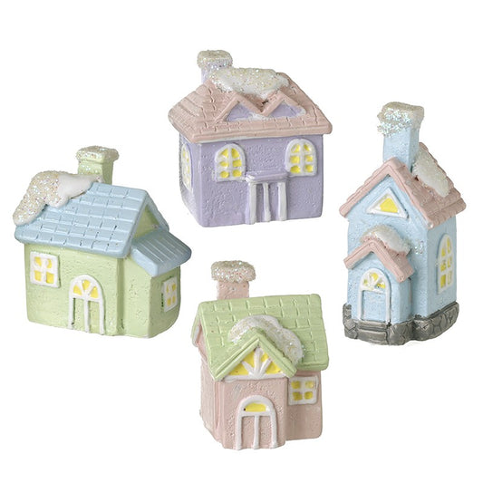 Set of miniature houses in pastel colors on a white background