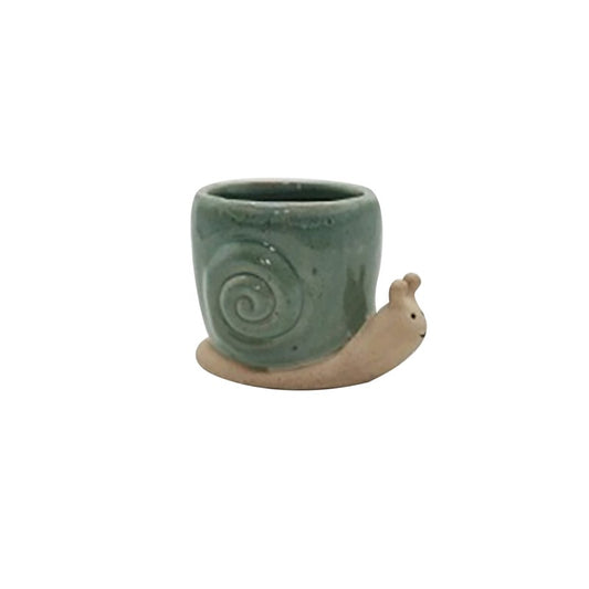 Ceramic snail-shaped planter with a green body on a white background