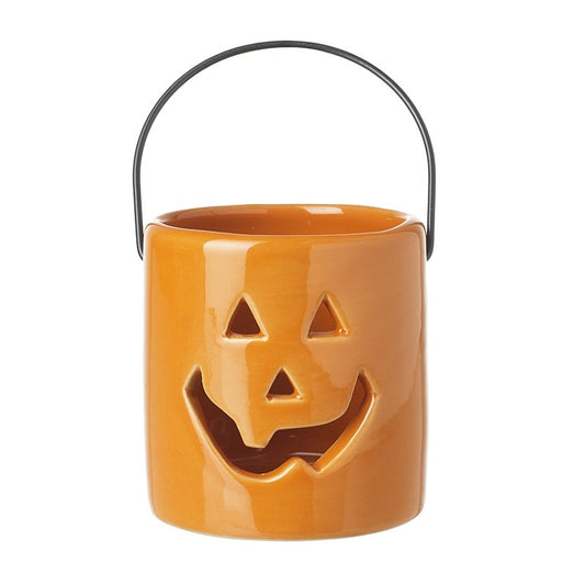 Orange ceramic bucket with a jack-o'-lantern face on a white background