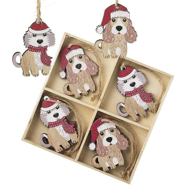 Set of dog-shaped Christmas ornaments with Santa hats and scarves in a box.