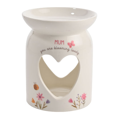Ceramic warmer with heart cutout and floral designs on a white background