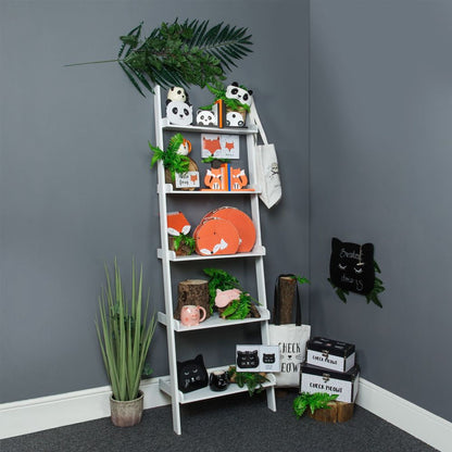 White ladder shelf against a gray wall with decorative items and plants.