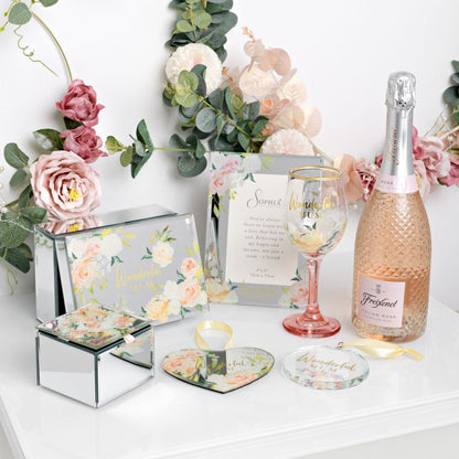 Bottle of Freixenet pink sparkling wine with decorative items on a white surface.