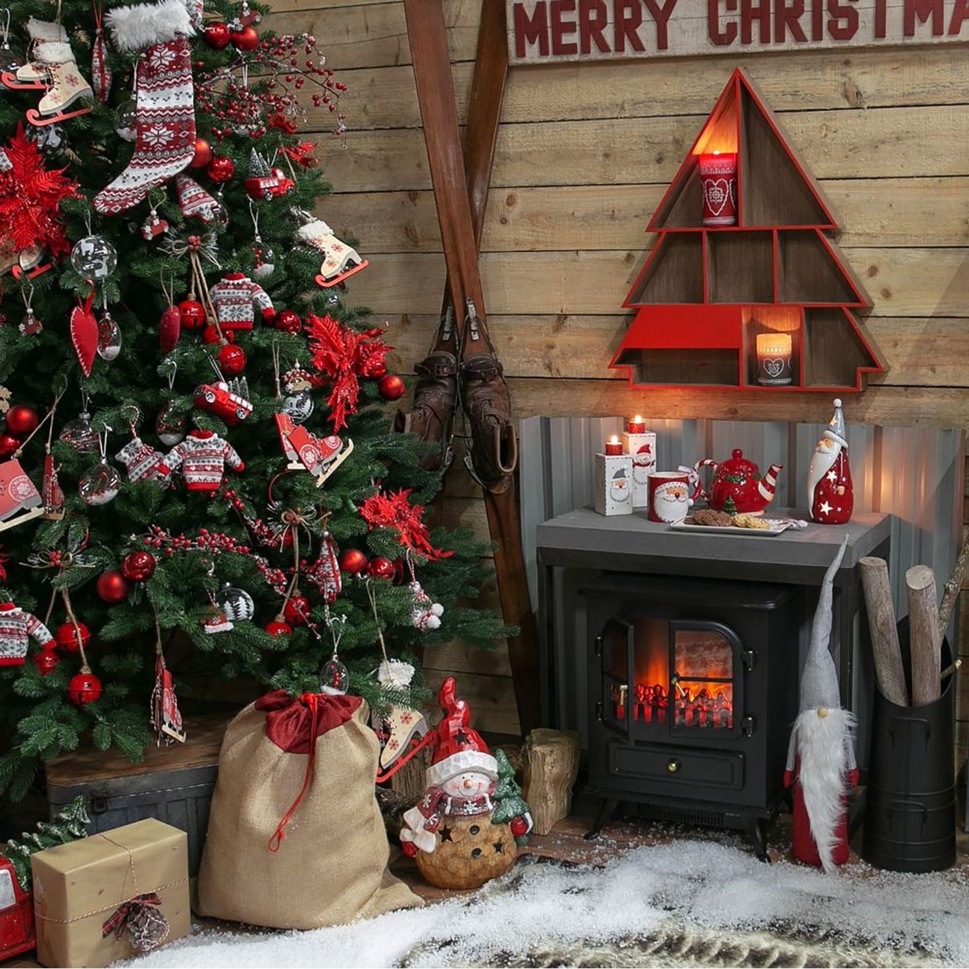 Christmas-themed room with decorated tree, fireplace, and festive decorations.