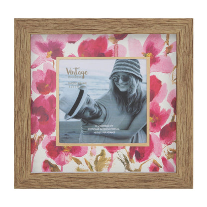 Wooden photo frame with floral design and a smaller photo of a person wearing sunglasses and a hat.