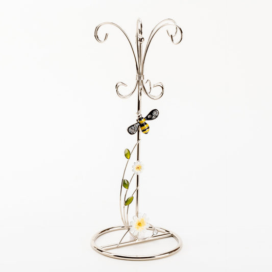Decorative metal stand with floral design on a white background