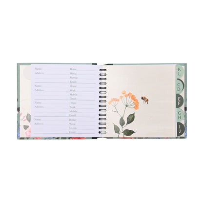 Open address book with floral design on a white background
