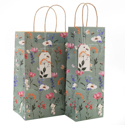 Floral-patterned bottle bags with a tag on a white background