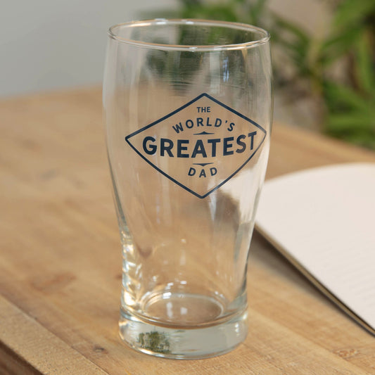 Clear glass with 'The World's Greatest Dad' text on a wooden surface