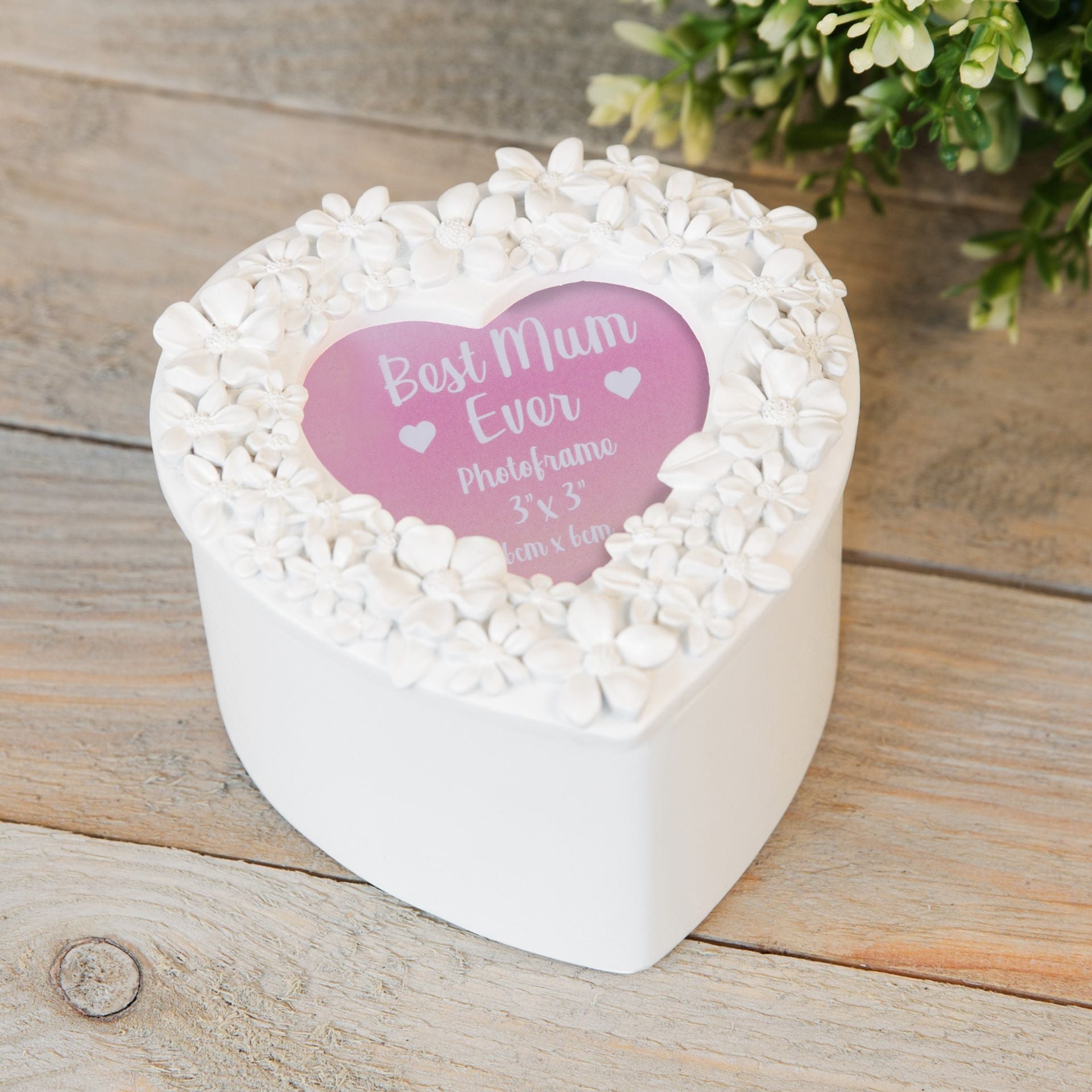 Heart-shaped white photo frame with 'Best Mum Ever' text on a wooden surface