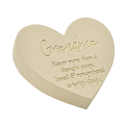 Heart-shaped beige stone with engraved text on a white background