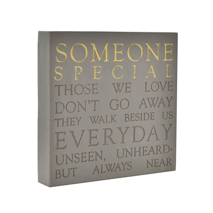 Decorative wall plaque with inspirational quote on a gray background