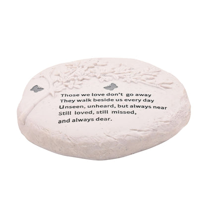 Decorative stone with engraved text and butterfly designs on a white background