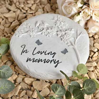 Round white stone with 'In loving memory' text and butterfly designs on a white background