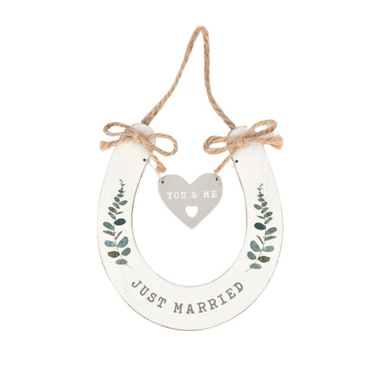 Decorative hanging sign with 'Just Married' and 'You & Me' text on a white background