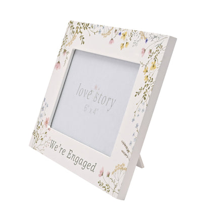 Floral photo frame with 'We're Engaged' and 'Love Story' text on a white background