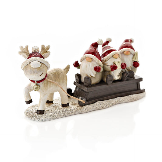 Decorative figurine of a reindeer pulling a sleigh with four gnomes on a white background