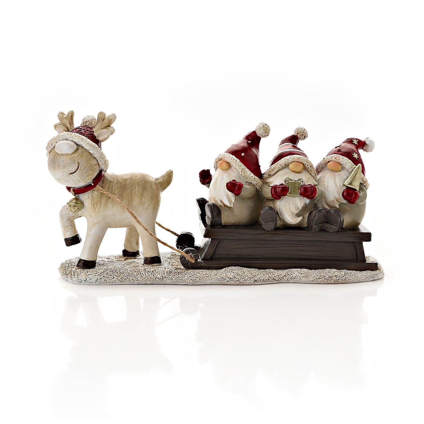 Decorative figurine of a reindeer pulling a sled with three Santa-like figures on a white background.