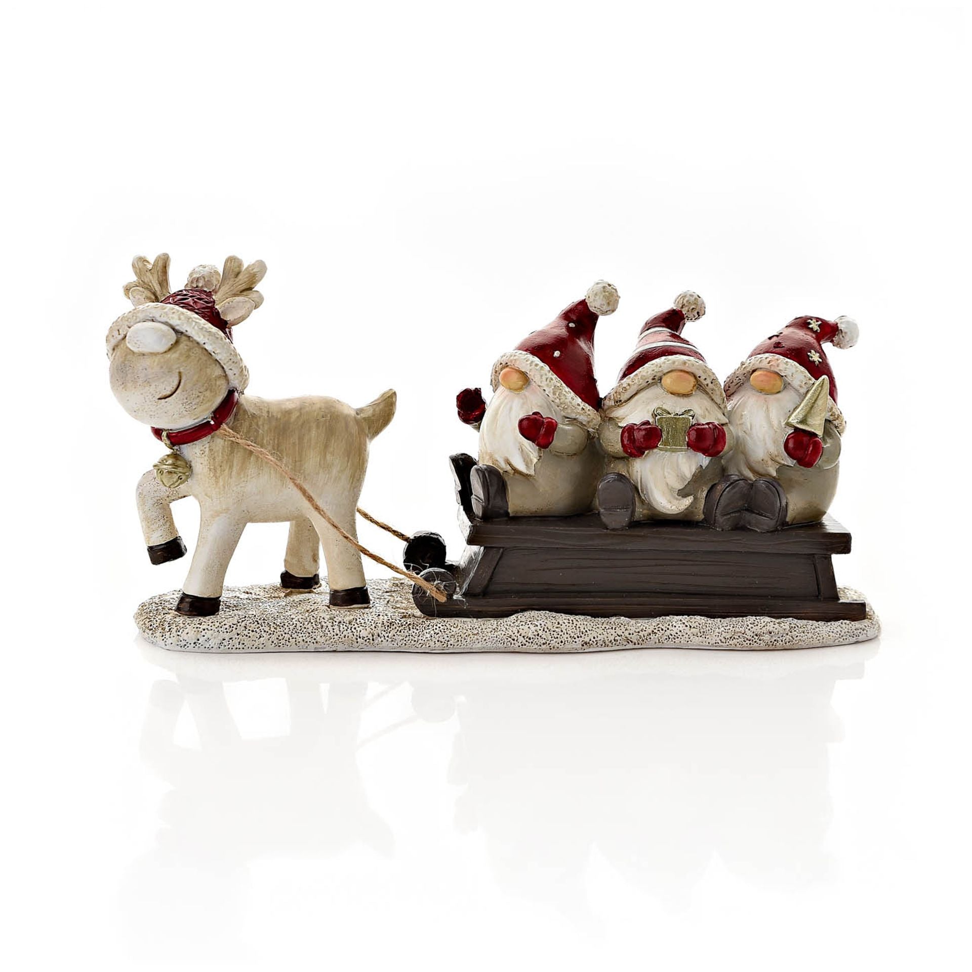 Decorative figurine of a reindeer pulling a sled with three Santa-like figures on a white background.