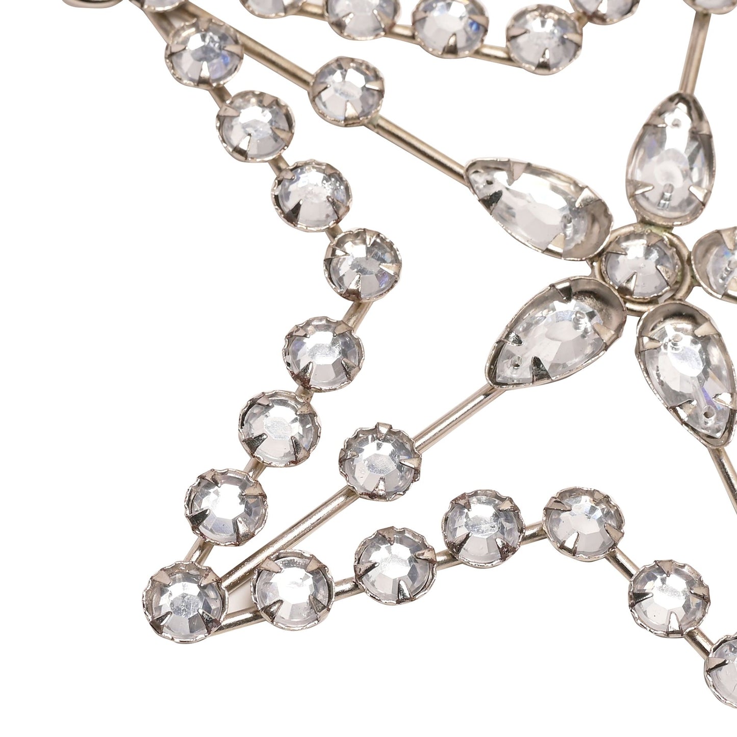 Decorative star hanging from a branch against a gray background