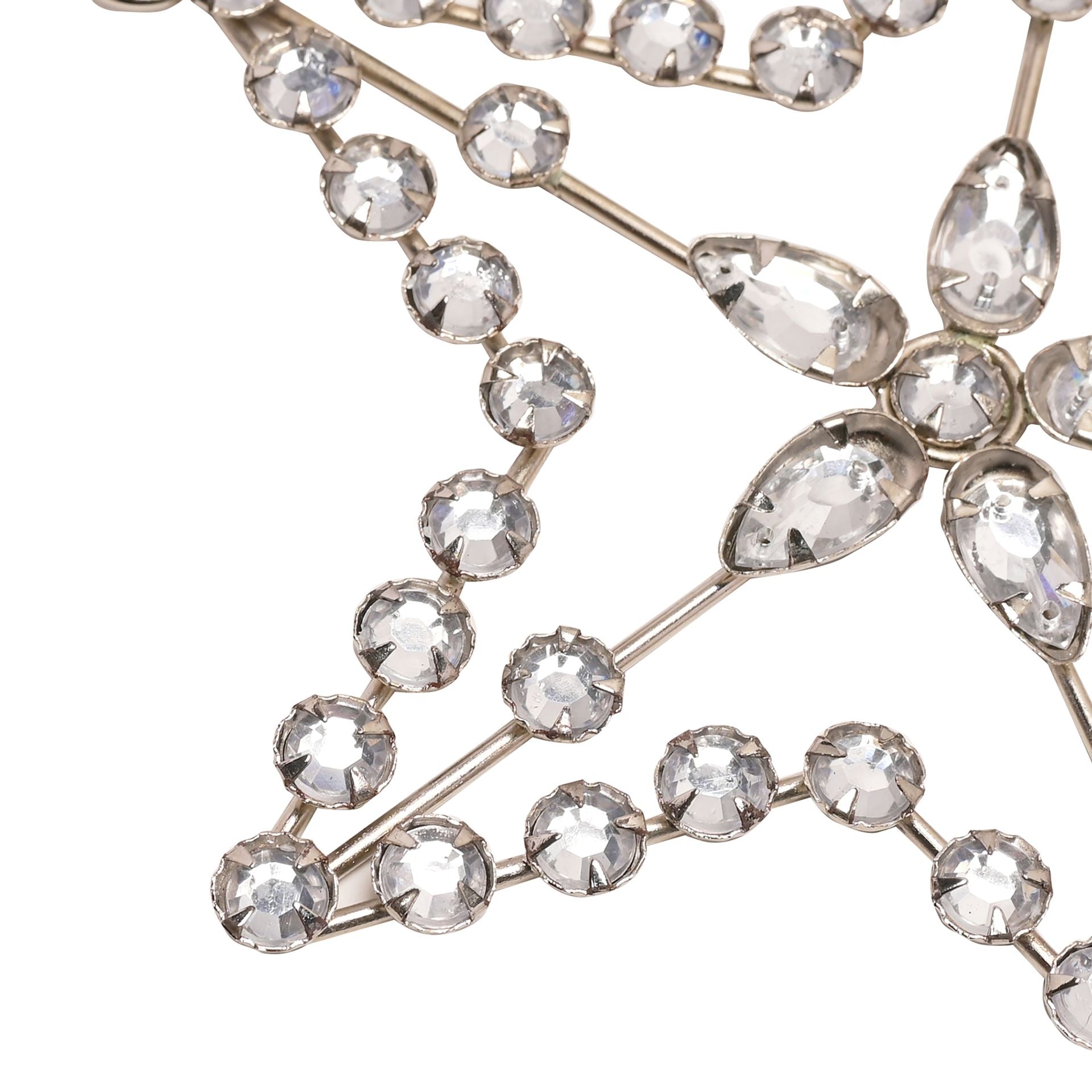 Decorative star hanging from a branch against a gray background