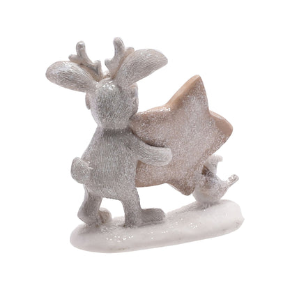 Decorative figurine of a reindeer holding a star on a white background