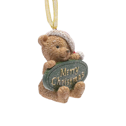 Teddy bear ornament holding a 'Merry Christmas' sign on a white background