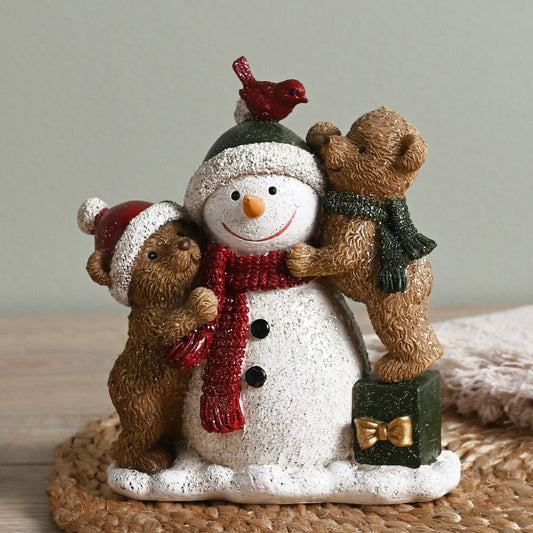 Decorative figurine of a snowman with two bears and a bird