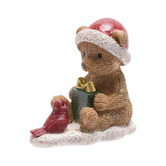 Christmas-themed figurine of a bear with a bird and gift box on a white background