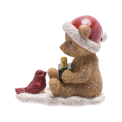 Christmas-themed figurine of a bear and bird with a Santa hat on a white background