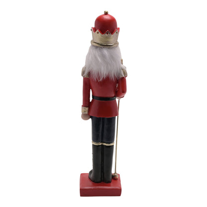 Nutcracker figurine in red uniform with a white beard on a white background